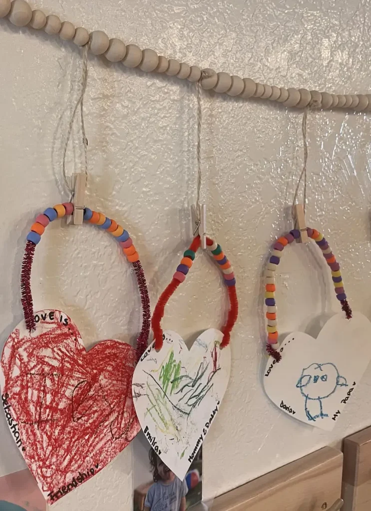 Children's handmade artwork displayed inside Here & There Preschool in Aventura